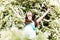 Woman relax in white summer flowers