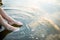 Woman relaxes by the lake sitting on the edge of a wooden jetty , Sunny joyful summer day or evening concept