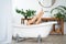Woman relaxing in bathroom, slim legs with smooth skin, foot care concept