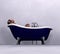 Woman relaxing in bathtub