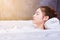 Woman relaxing in bathtube with eyes closed in bathroom