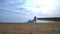 Woman relaxing beach. Beautiful woman lying on sea beach. Woman in blue dress