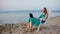 Woman relaxing at the beach with her laptop talking skype