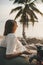 Woman relaxing on beanbag at the beach and making timelapse video with her camera on tripod