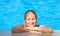 Woman relaxing in blue outdoor swimming waterpool