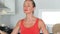 Woman relaxing and breathing during yoga meditation in lotus pose on kitchen