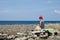 Woman relaxing with coffee break by the coast