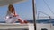 woman relaxing on a cruise catamaran sail boat wearing white summer dress