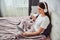 Woman relaxing with a cup of coffee and tablet