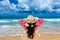 Woman relaxing on deck chair at beach and looking at ocean