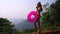 Woman relaxing at the edge of infinity swimming pool at resort rubber ring hills and mountain view