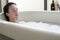 Woman Relaxing With Eyes Closed In Bathtub