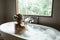 Woman relaxing in foam bath with bubbles in dark bathroom by window