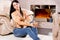 Woman relaxing in front of a warm fire