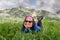 Woman relaxing on grass at high alpine meadows on hiking day