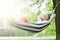 Woman Relaxing In Hammock