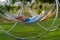 Woman relaxing in a hammock enjoying the last rays of the sun