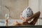 Woman relaxing at home in the hot tub bath ritual,drinking wine.Relaxing spa night in bathroom.Good personal hygiene routine.Skin,