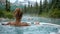 Woman Relaxing in Hot Tub With Mountain View
