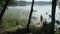 Woman relaxing on the lake, standing on the edge of a wooden pier