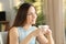 Woman relaxing looking at side holding coffee cup