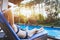 Woman relaxing in luxury tropical resort hotel near swimming pool