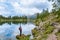 Woman relaxing near by beautiful lake Federa in Dolomites Italy