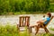 Woman relaxing on norwegian fjord shore