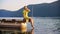 Woman relaxing on pier and touching sea water with feet