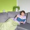 Woman relaxing reading on a sofa