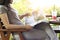 Woman relaxing by reading travelling magazine and strawberry smoothie on table