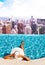 Woman relaxing in the rooftop pool with view of New York