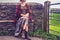 Woman relaxing by rural stone wall