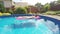 Woman relaxing in a small home swimming pool