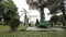 Woman relaxing in summer Batumi park, green trees and flowers in city garden