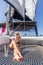 Woman relaxing on a summer sailing cruise, sitting on a luxury catamaran near picture perfect Palau town, Sardinia