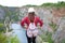 Woman relaxing on a top of canyon in Czech Republic. Making selfie. Traveler lifestyle. Woman with bag and hat.