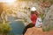 Woman relaxing on a top of canyon in Czech Republic. Making selfie. Traveler lifestyle. Woman with bag and hat.