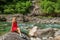 woman relaxing by Verzasca riverside