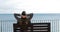 Woman relaxing watching ocean in a bench