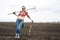 Woman rely on shovel and rake