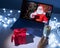 Woman remotely talking with Santa Claus on a video call on your computer. A man dressed as Santa Claus congratulates his