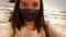 Woman removes end quarantine mask in store