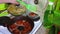 The woman removes from the frying pan ready cutlets from salmon meat.