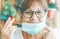 Woman removes surgical mask and smiles after lockdown of coronavirus pandemic - hope and return to normal after pandemic concept
