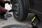 A woman removes the wheel with a key near her car with a flat tire