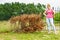 Woman removing dried thuja tree from backyard