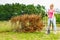 Woman removing dried thuja tree from backyard