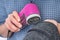 Woman is removing lint with fabric shaver or fuzz remover