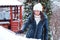 Woman removing snow from car window. Girl cleaning snow from car with brush. Car in snow after snowstorm. Transportation, winter,